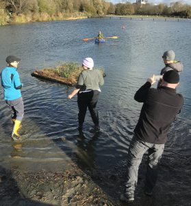 Small floating island towed into place after being assembled on the lake edge.
